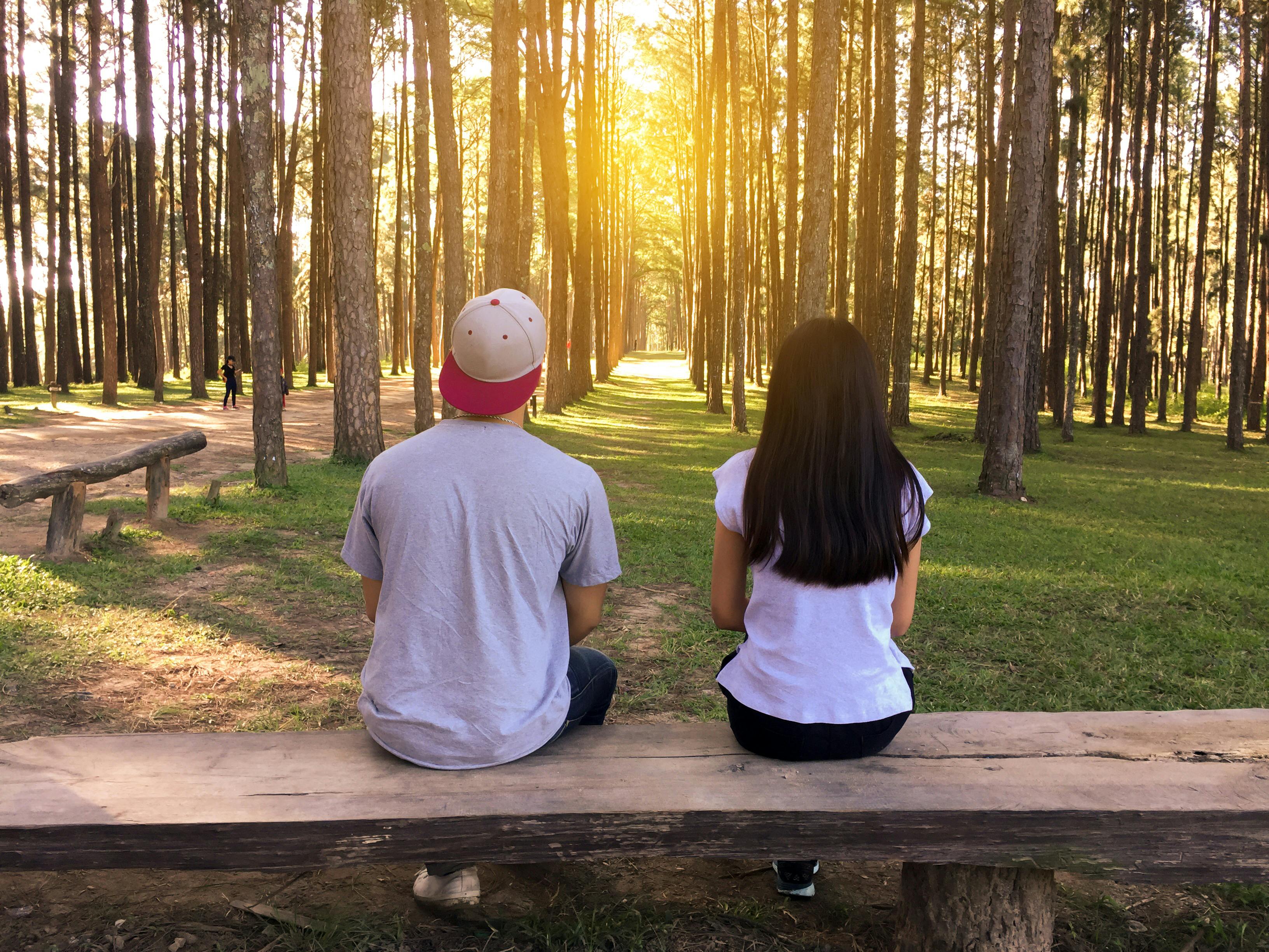 Man and woman on bench in woods